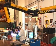 employee welding in machine shop